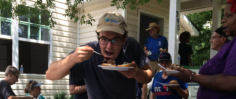 Habitat crew member digs into a plate of barbecue