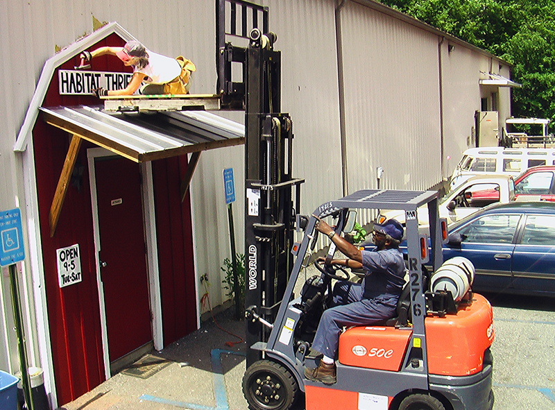 JP Watkins directs installation of the "barn door" at the current Athens Habitat ReStore on Barber Street, 2002