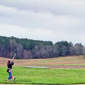 A competitor breaks a clay in the Ladies' Charity Skeet Classic 2020