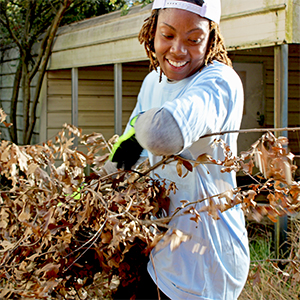 A volunteer clears brush at the future Micah's Creek location