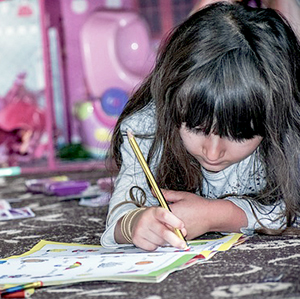 Little girl with book and pencil