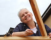 Program volunteer attaches a truss with woodscrews