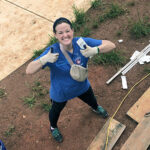 A volunteer from Zaxby's gives a double thumbs-up on a Habitat build site