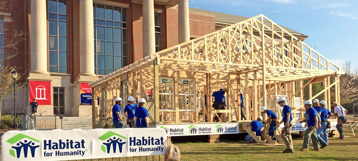 Habitat for Humanity workers build a house frame on the lawn of the Special Collections Library at the University of Georgia in Athens, GA