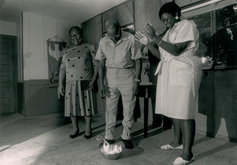 Bo and Emma Johnson burn their mortgage papers in a mixing bowl in the kitchen of their home in Americus, GA